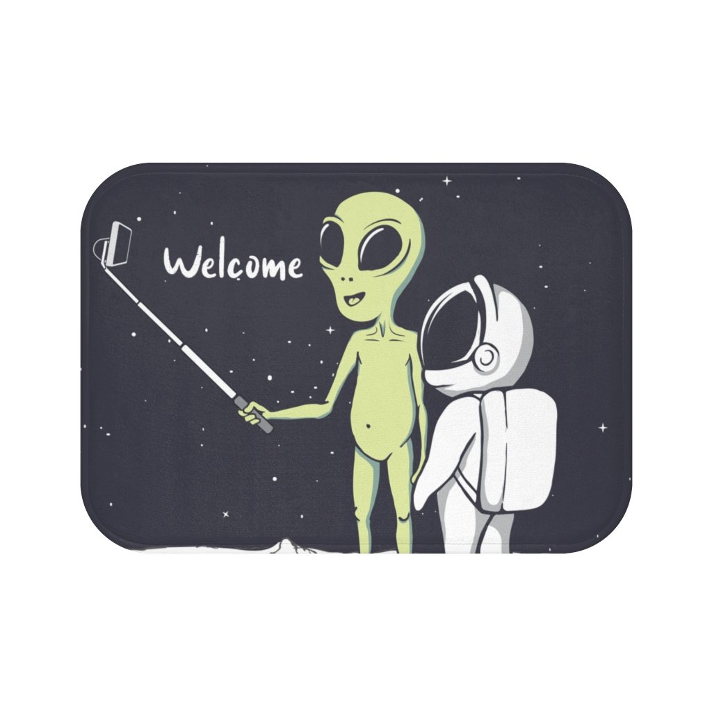 A colorful bath mat featuring a playful alien taking a selfie, designed with anti-slip backing and durable edges.