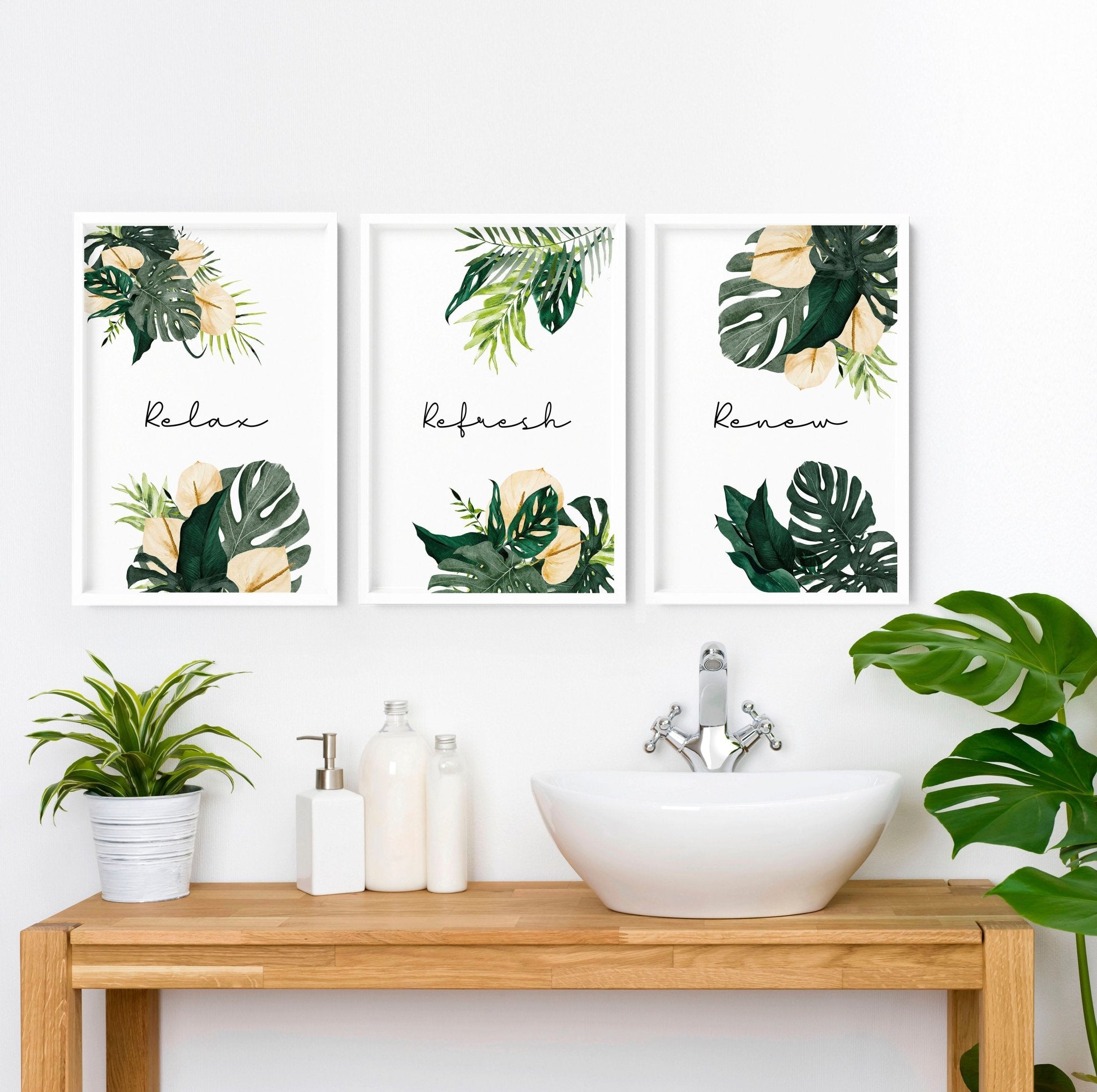 Set of 3 tropical wall art prints featuring vibrant monstera leaves and flowers with calming quotes, perfect for bathroom decor.