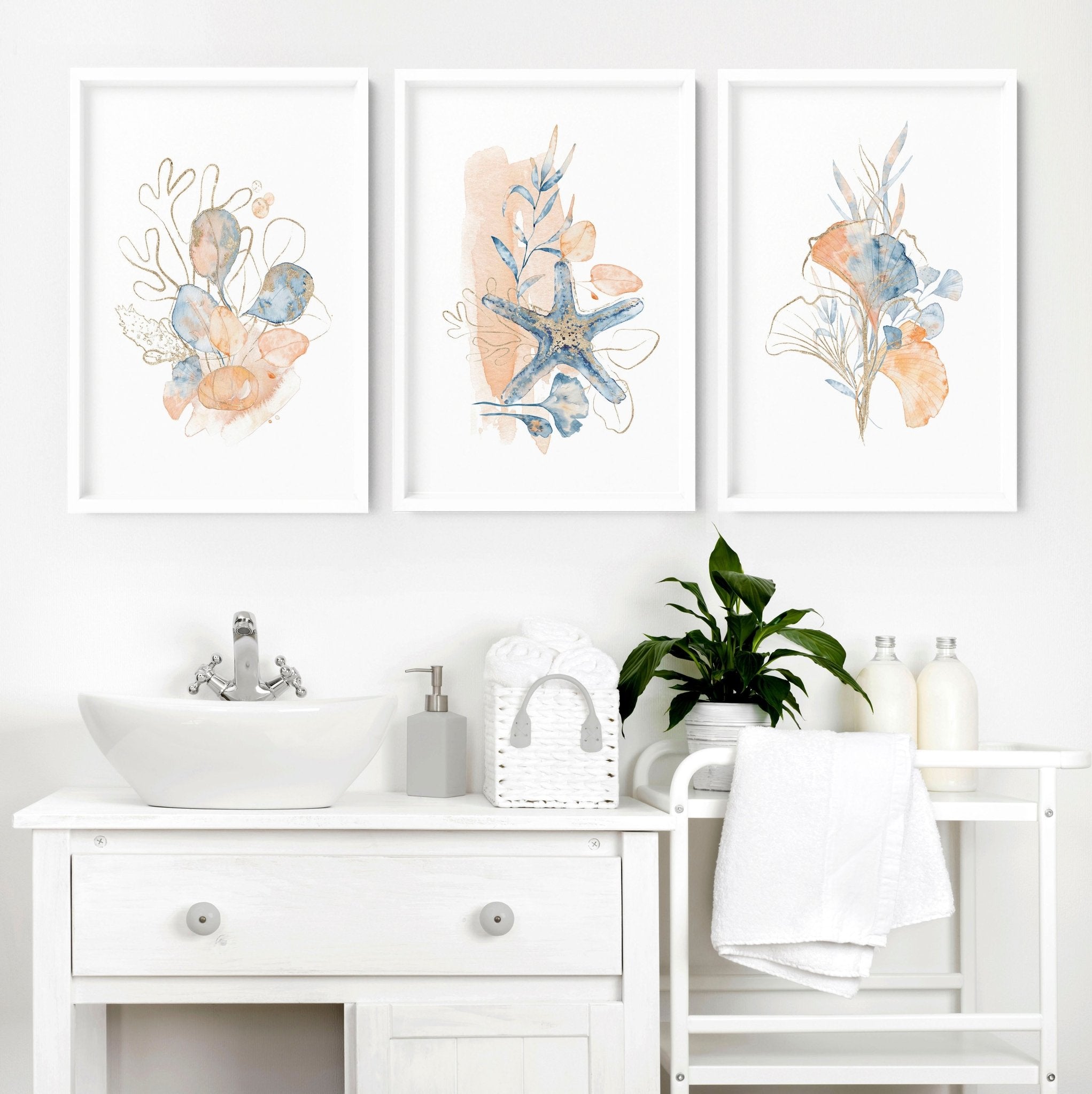 Set of 3 coastal-themed wall art prints featuring muted tones of blue, blush pink, and red, designed for bathroom decor.