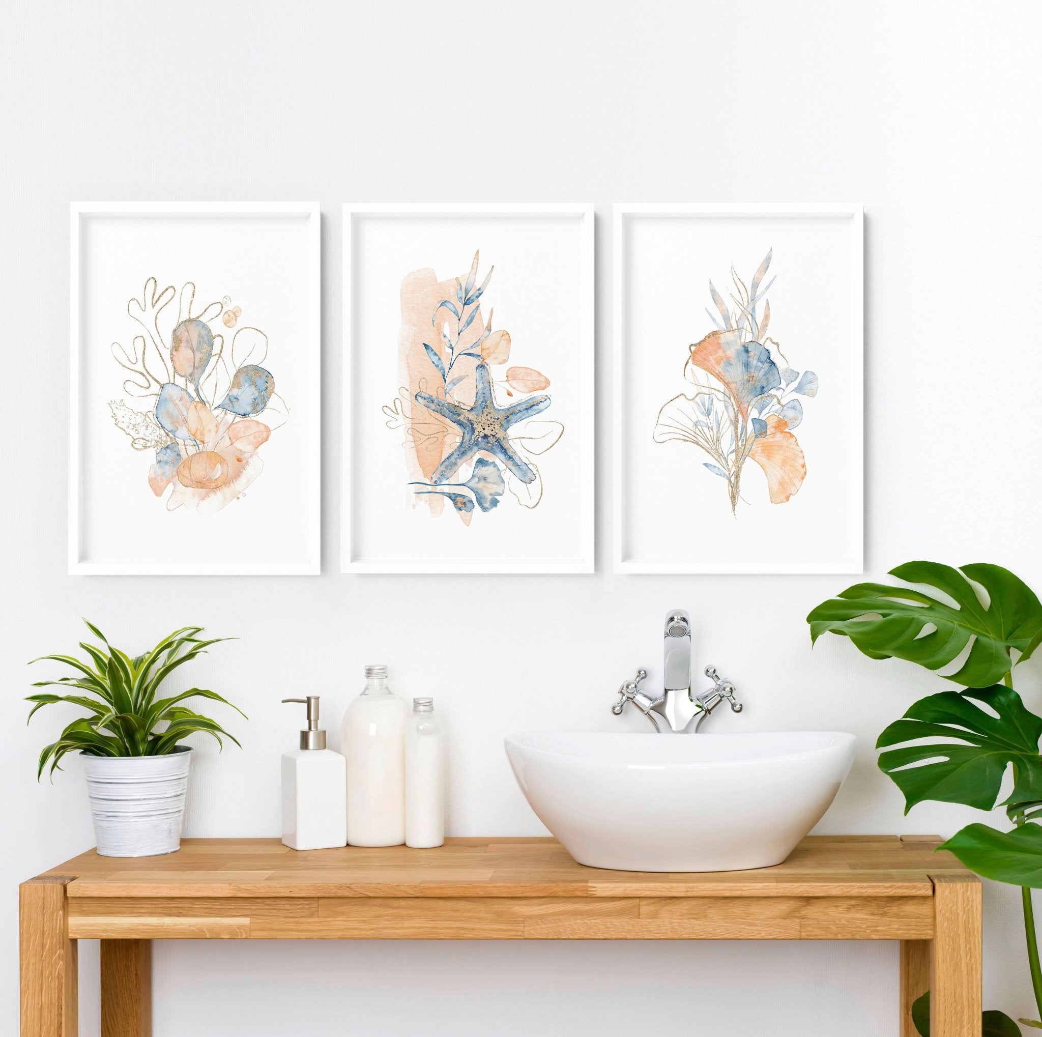 Set of 3 coastal-themed wall art prints featuring muted tones of blue, blush pink, and red, designed for bathroom decor.