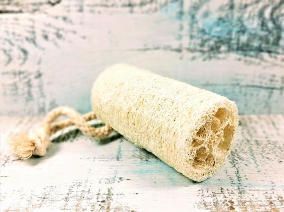 Organic Natural 4" Loofah made from luffa fibers, showcasing its natural texture and size, perfect for exfoliating skin.