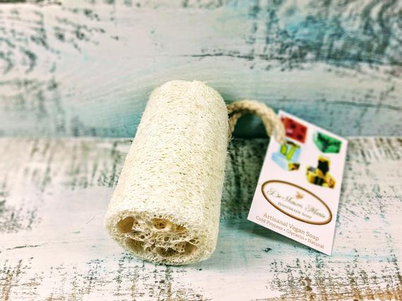 Organic Natural 4" Loofah made from luffa fibers, showcasing its natural texture and size, perfect for exfoliating skin.