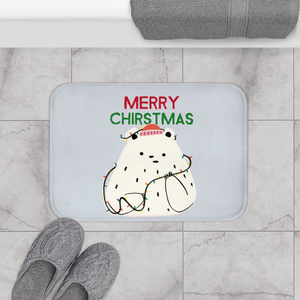 A festive bath mat featuring a playful polar bear surrounded by colorful Christmas lights, perfect for holiday home decor.