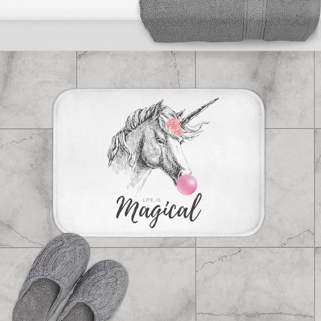 A colorful bath mat featuring a whimsical unicorn design, made of soft microfiber with anti-slip backing for safety.