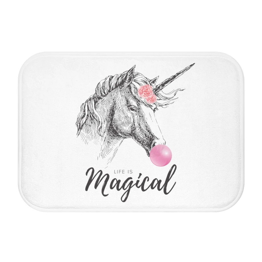 A colorful bath mat featuring a whimsical unicorn design, made of soft microfiber with anti-slip backing for safety.