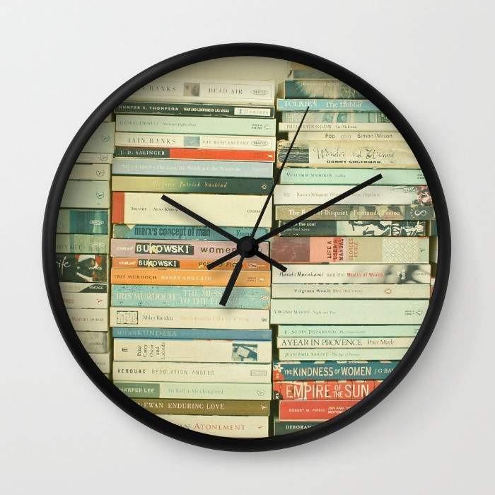 Bookworm Wall Clock with black or white frame, 10 inches in diameter, featuring a clear plexiglass face and stylish hands.