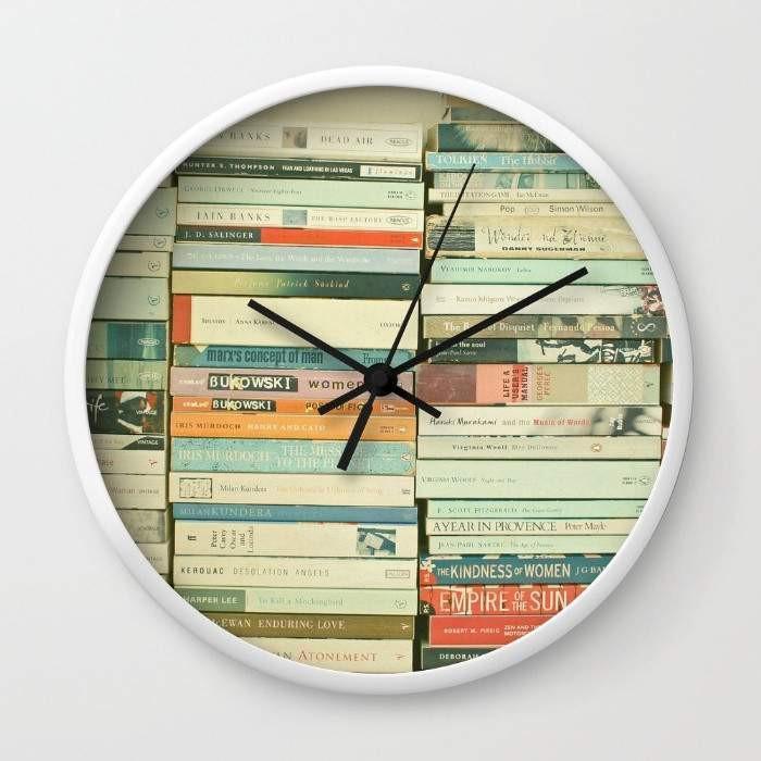 Bookworm Wall Clock with black or white frame, 10 inches in diameter, featuring a clear plexiglass face and stylish hands.