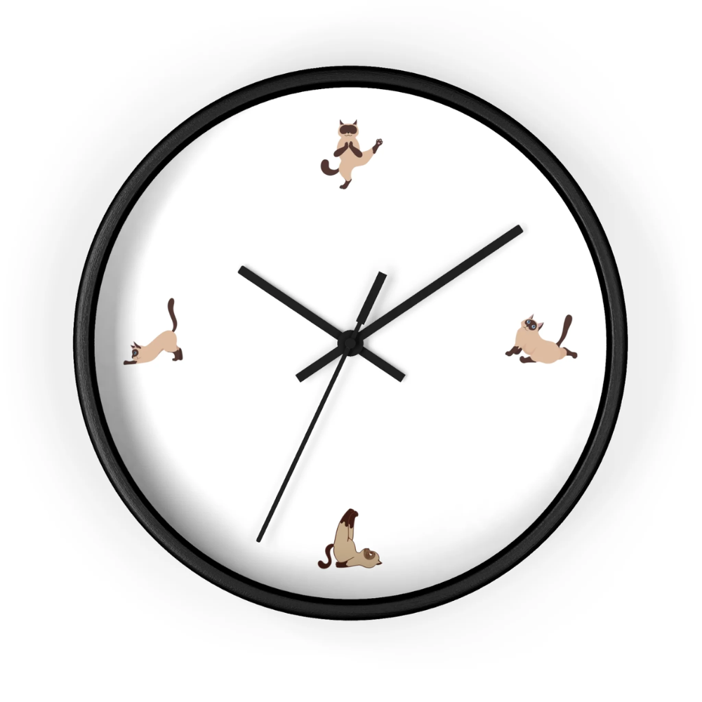 A whimsical wall clock featuring a cat doing yoga poses, set in a wooden frame with a clear plexiglass face, perfect for indoor decor.