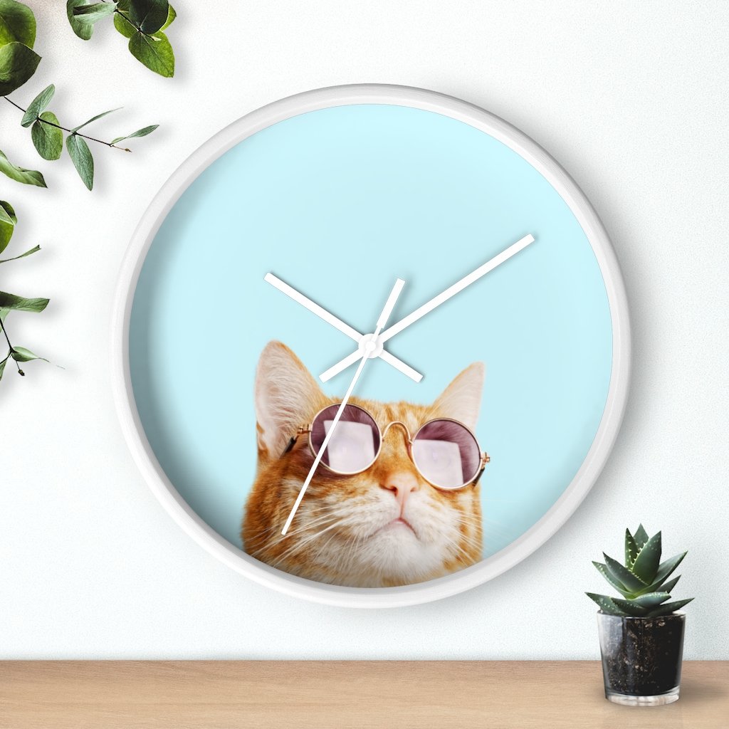 A whimsical wall clock featuring a cat design with a wooden frame and plexiglass face, ideal for indoor use.