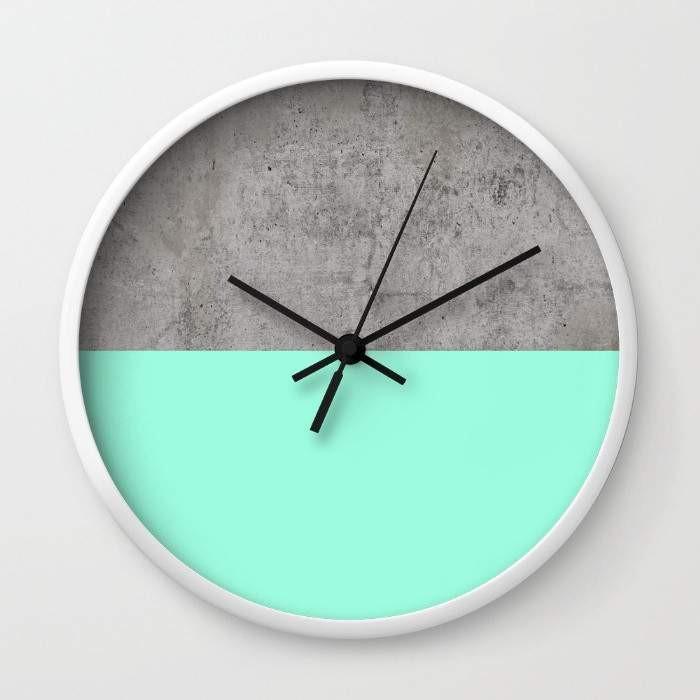 A stylish Sea on Concrete Wall Clock featuring a unique sea-inspired design, available in black or white frames, with a clear plexiglass face.