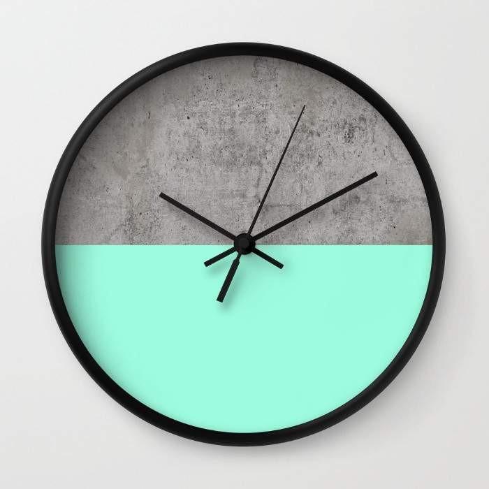 A stylish Sea on Concrete Wall Clock featuring a unique sea-inspired design, available in black or white frames, with a clear plexiglass face.