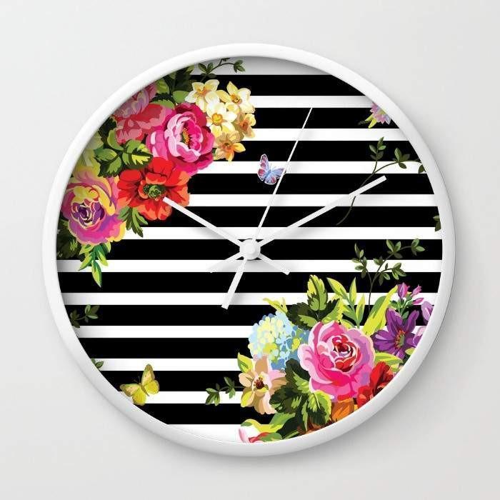 A stylish Stripes Floral Wall Clock with a floral design and striped background, available in black or white frame, showcasing its high-impact plexiglass face.