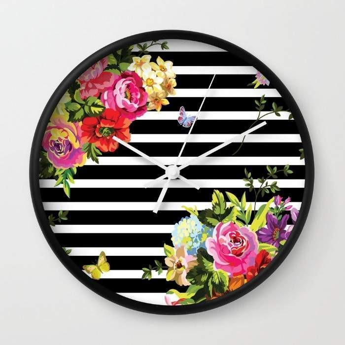 A stylish Stripes Floral Wall Clock with a floral design and striped background, available in black or white frame, showcasing its high-impact plexiglass face.