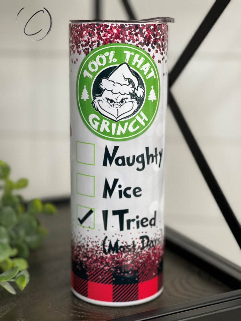 A 20oz skinny tumbler featuring a vibrant Grinch design, perfect for holiday drinks, with a reusable straw included.