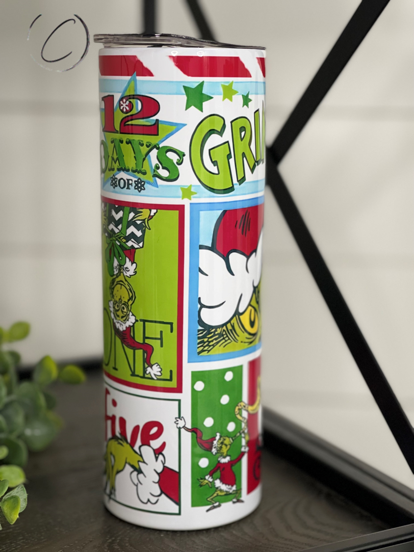 A colorful 20oz skinny tumbler featuring a festive Grinchmas design, complete with a reusable straw, perfect for holiday beverages.