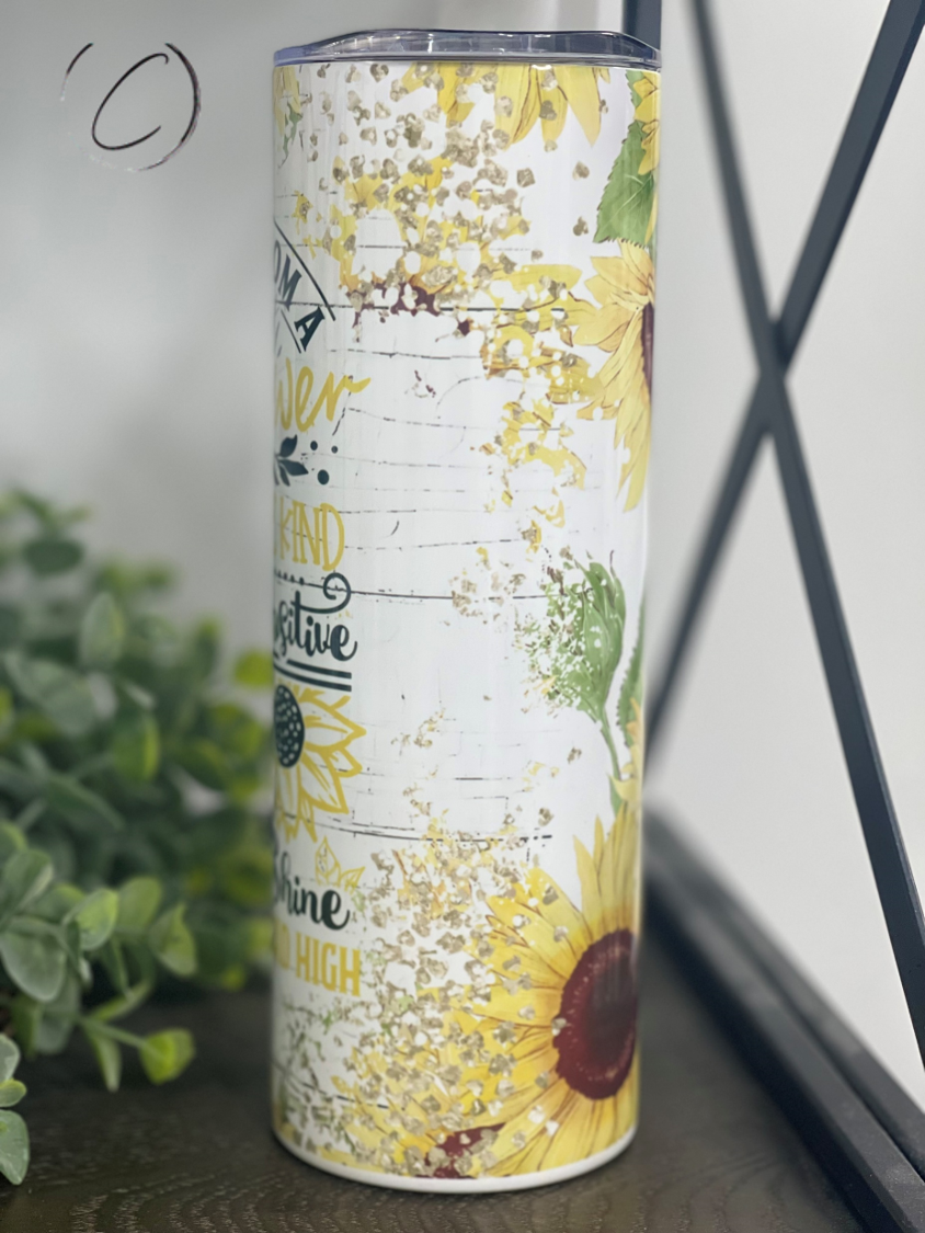 20oz skinny tumbler featuring a vibrant sunflower design, perfect for hot and cold beverages.