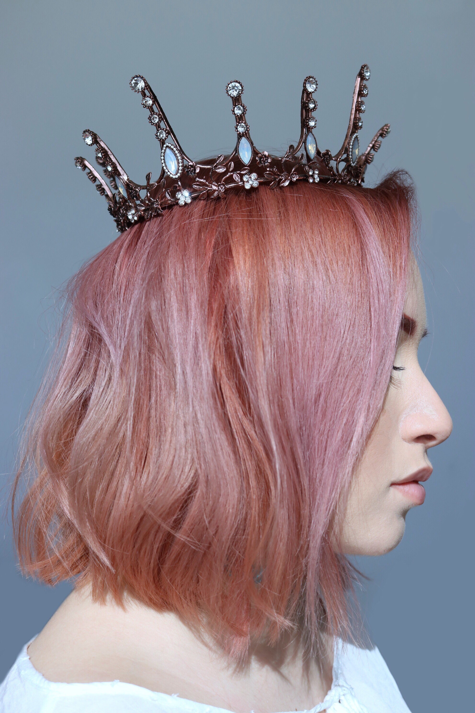 Aggressively Rosy Crown Tiara in rose gold with faux opal accents, designed to resemble skyscrapers, perfect for royal occasions.