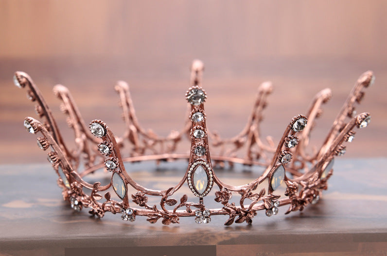 Aggressively Rosy Crown Tiara in rose gold with faux opal accents, designed to resemble skyscrapers, perfect for royal occasions.