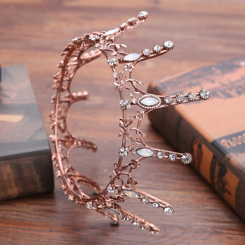 Aggressively Rosy Crown Tiara in rose gold with faux opal accents, designed to resemble skyscrapers, perfect for royal occasions.