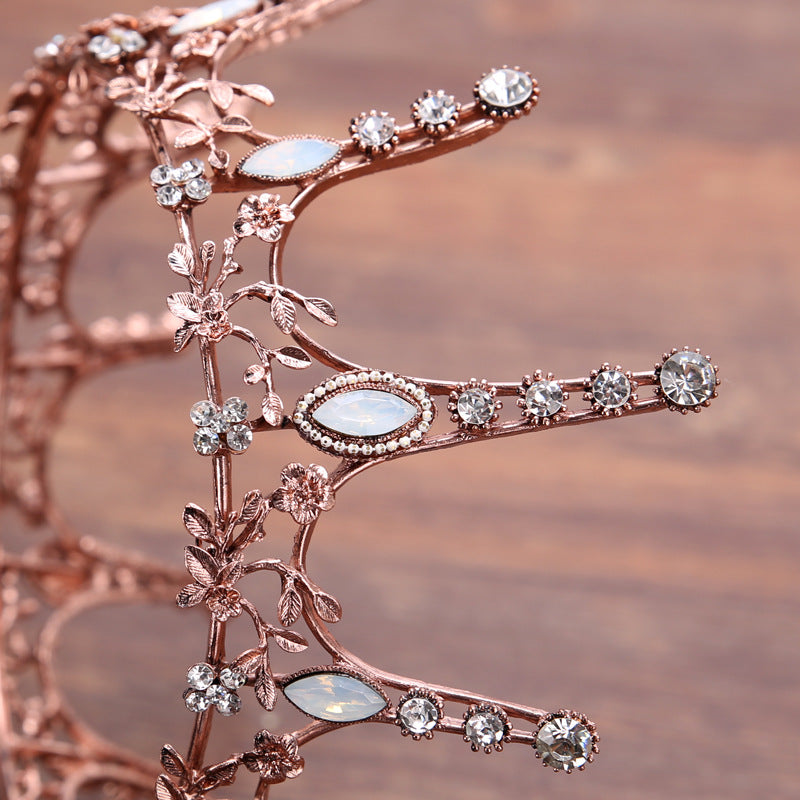 Aggressively Rosy Crown Tiara in rose gold with faux opal accents, designed to resemble skyscrapers, perfect for royal occasions.