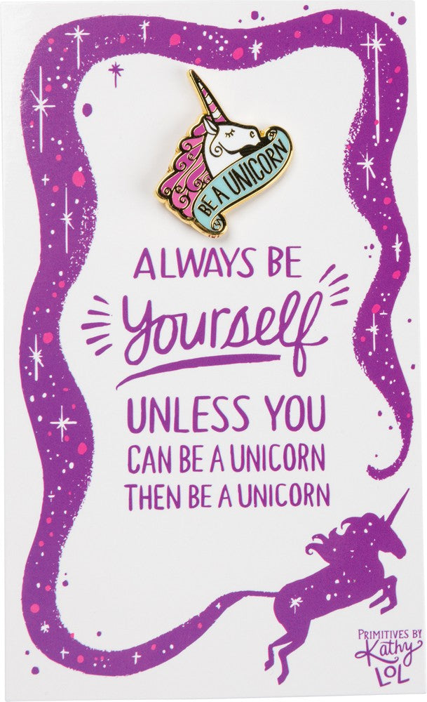 A colorful unicorn enamel pin on a gift card featuring an inspirational quote about being yourself.