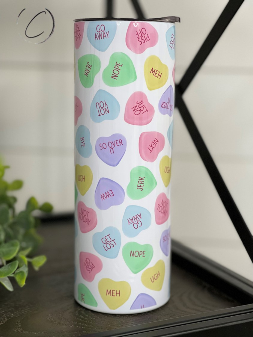 Anti Valentines Conversation Hearts 20oz Skinny Tumbler with colorful heart designs, featuring a reusable straw.