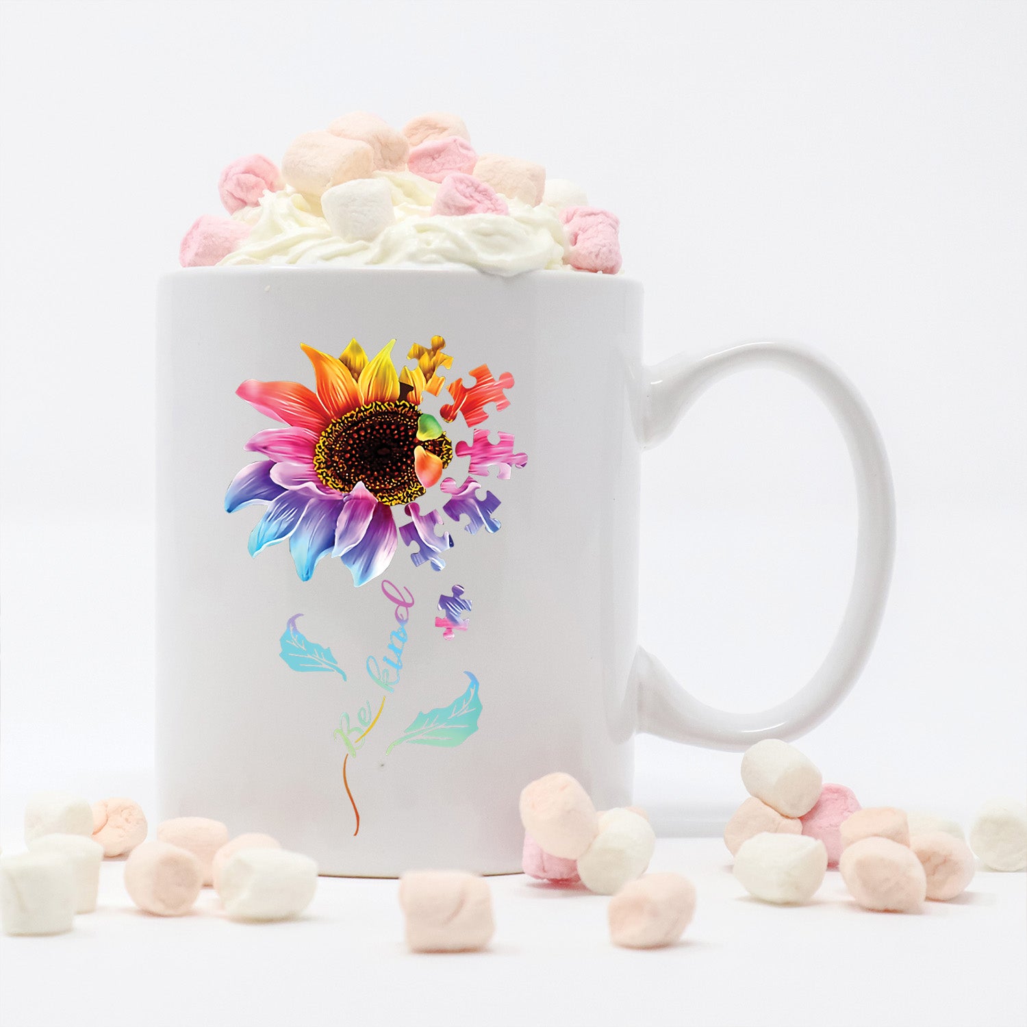 A glossy white ceramic mug featuring a colorful puzzle flower design, symbolizing autism awareness, perfect for coffee or tea.