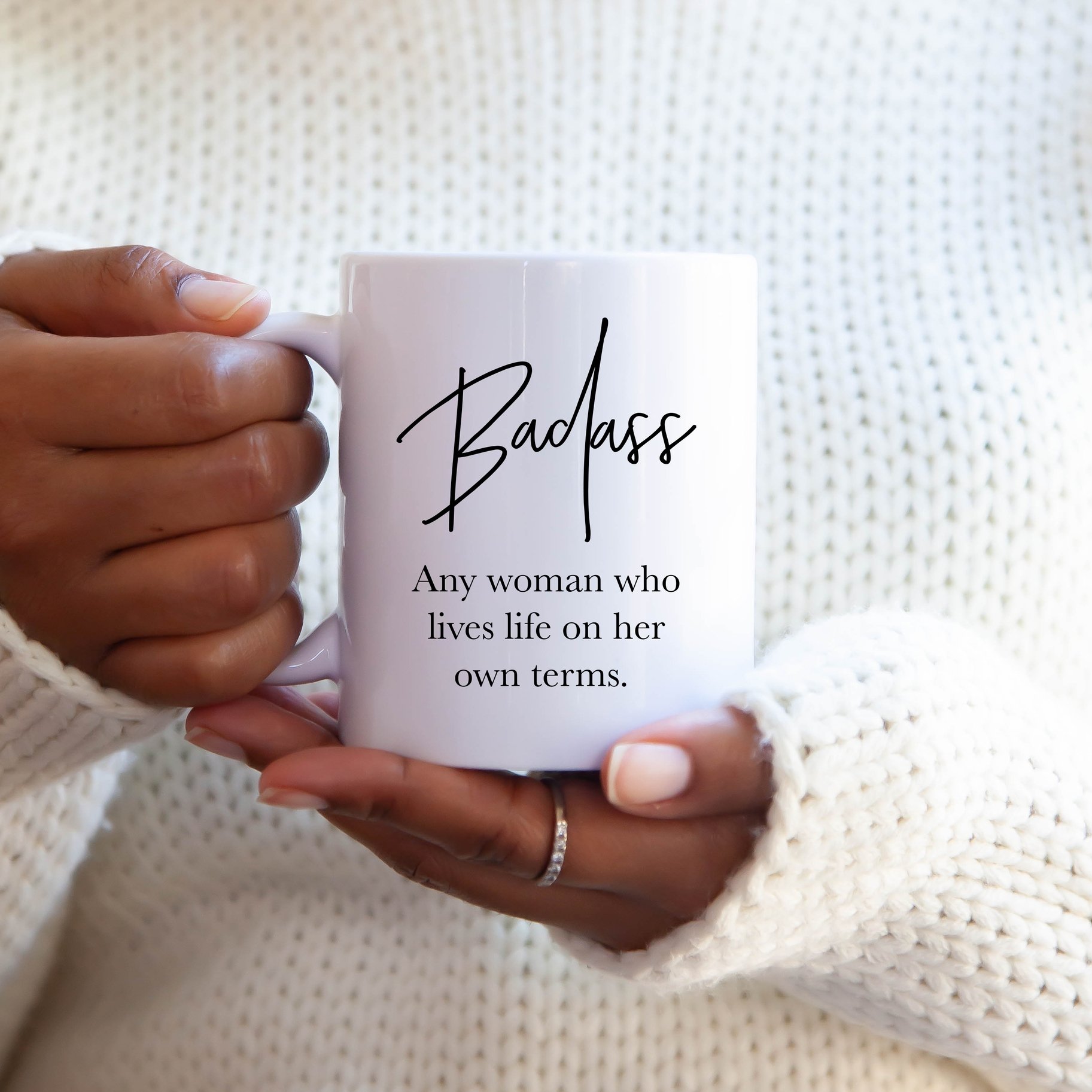 A glossy white ceramic mug with the phrase 'Badass Woman' printed in vibrant colors, showcasing its oversized 15-ounce capacity.