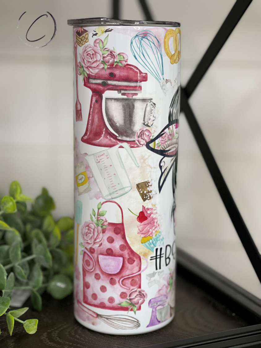 A stylish 20oz skinny tumbler with a full wrap design featuring vibrant graphics, accompanied by a reusable straw.