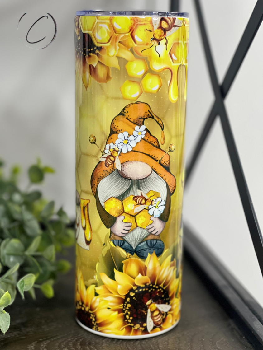 Bee Happy Gnomes 20oz Skinny Tumbler featuring a whimsical gnome design, perfect for hot and cold beverages.