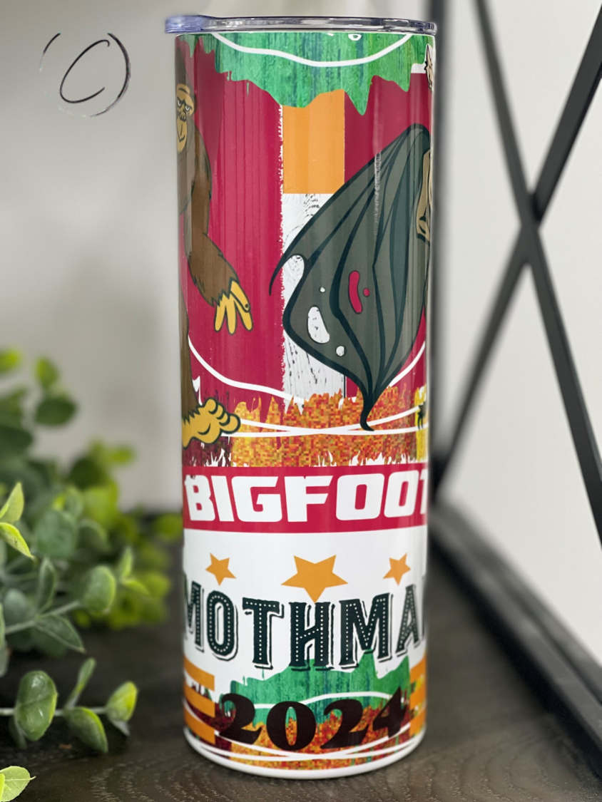 Bigfoot & Mothman 2024 20oz Skinny Tumbler with a vibrant full wrap design featuring cryptid illustrations.