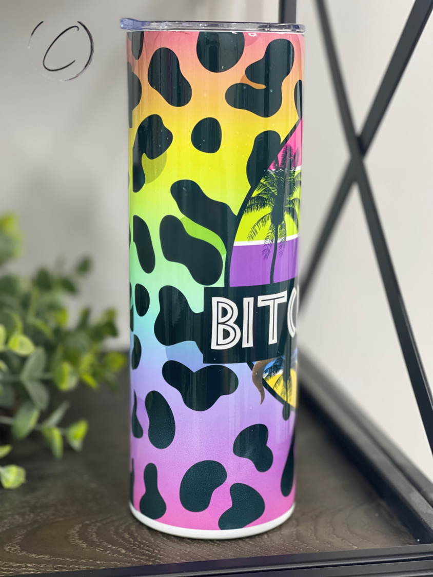 Bitchasaurus 20oz Skinny Tumbler with vibrant design and reusable straw, showcasing its durable construction.