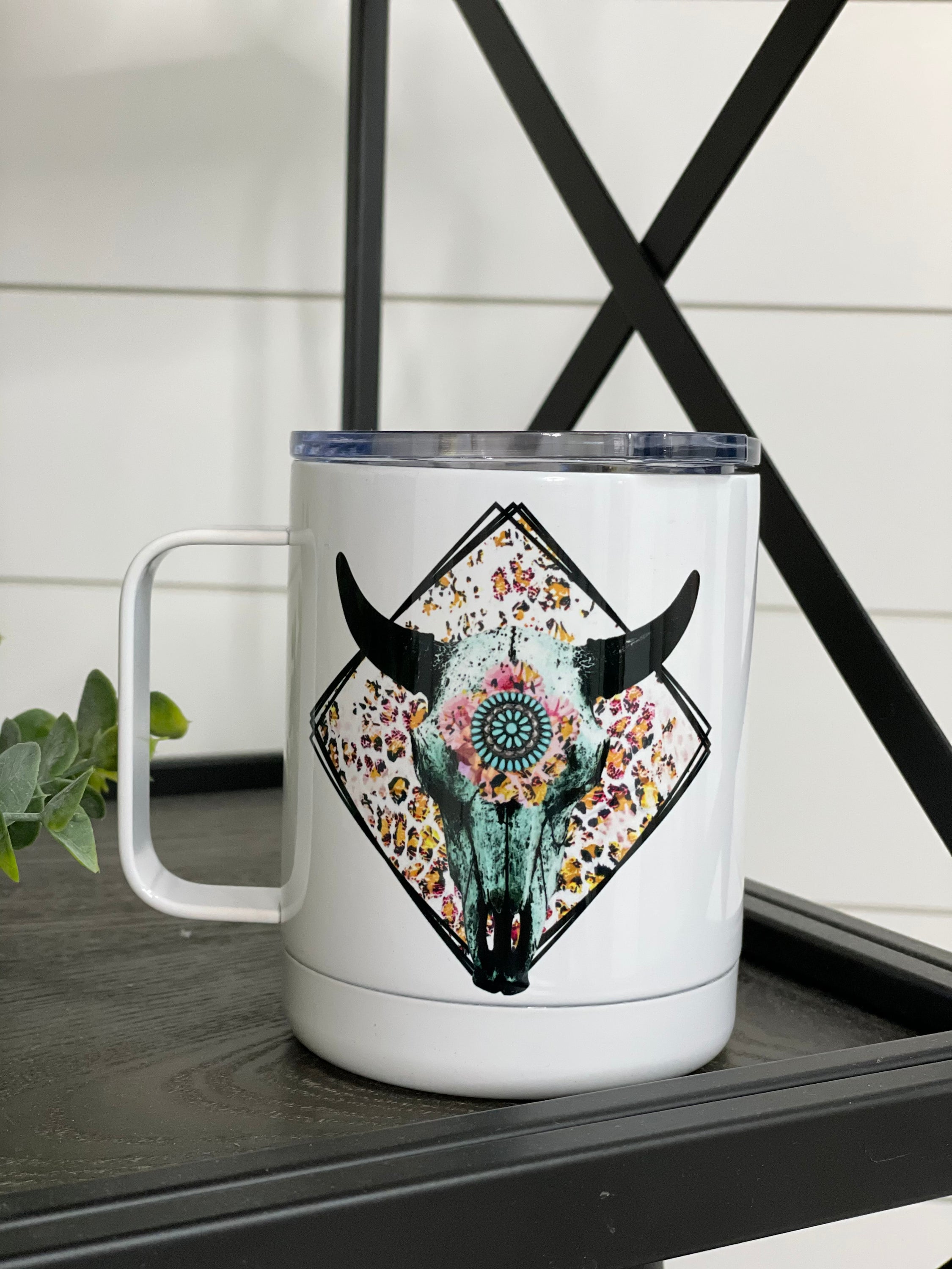 Boho Bull Skull 11oz Travel Mug with a unique design on both sides, featuring a rubber sealed lid for spill protection.