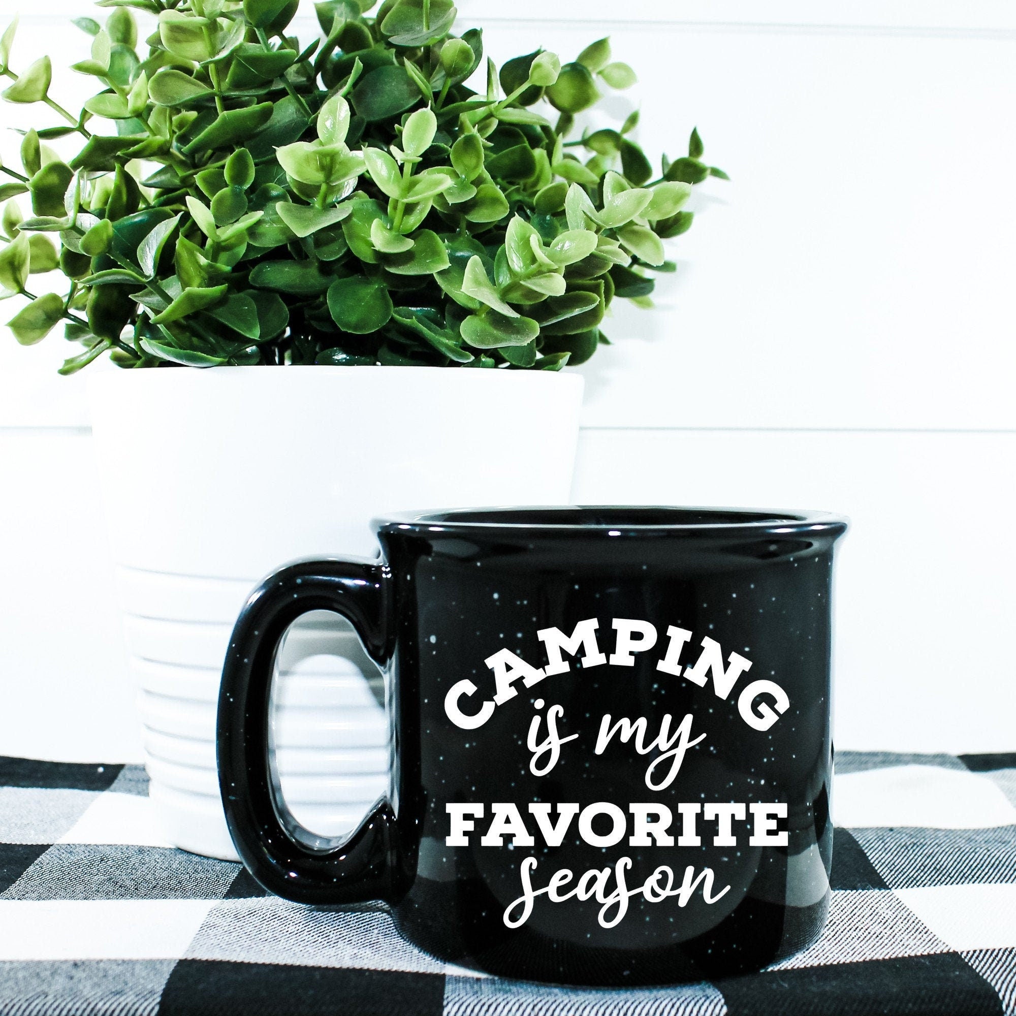 Ceramic campfire mug with 'Camping Is My Favorite Season' design, perfect for outdoor enthusiasts.