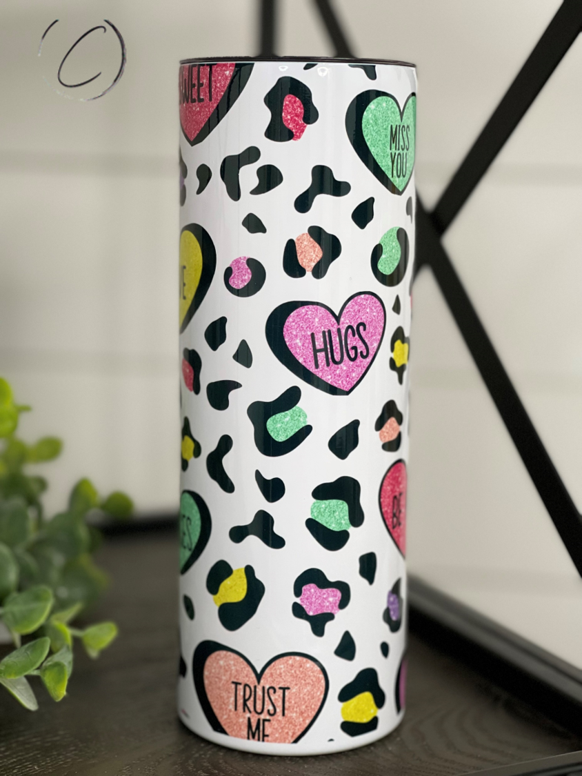 Cheetah Conversation Hearts 20oz Skinny Tumbler with a vibrant cheetah print and colorful conversation heart design.