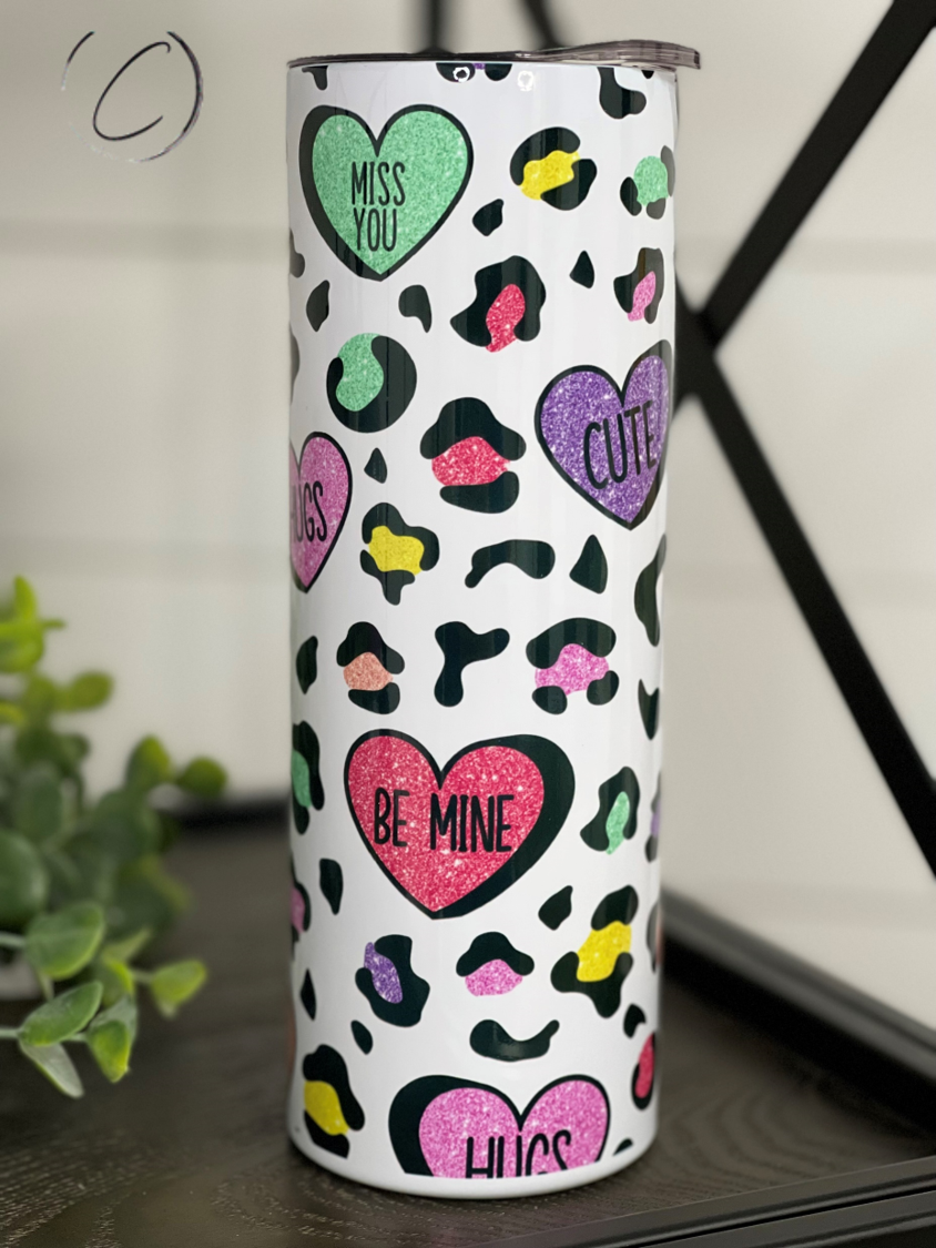 Cheetah Conversation Hearts 20oz Skinny Tumbler with a vibrant cheetah print and colorful conversation heart design.