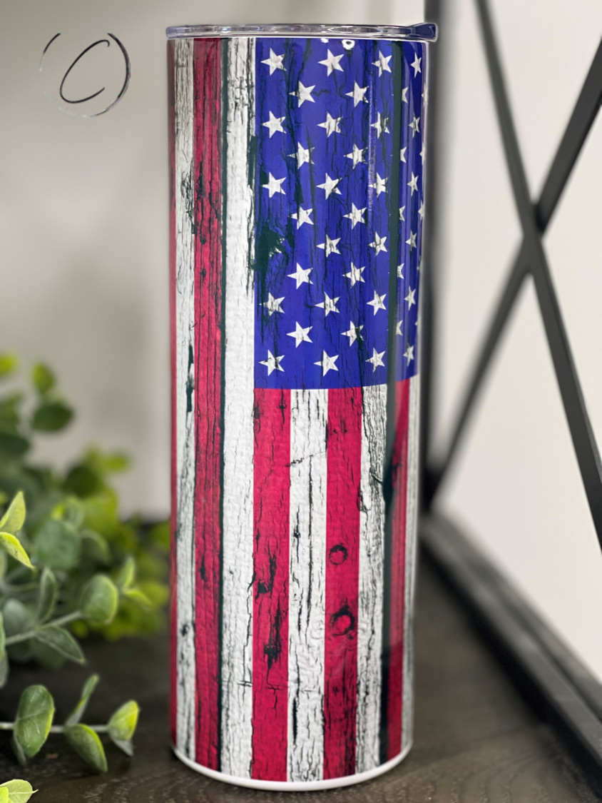 Distressed American Flag 20oz Skinny Tumbler with a vibrant design, featuring a full wrap print and a reusable straw.