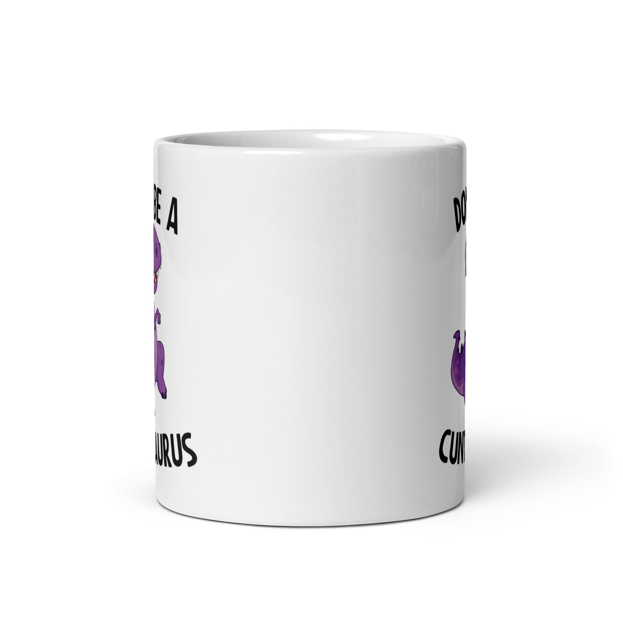 A glossy ceramic mug featuring the humorous phrase 'Don't Be A Cuntasaurus' printed on both sides, available in two sizes.