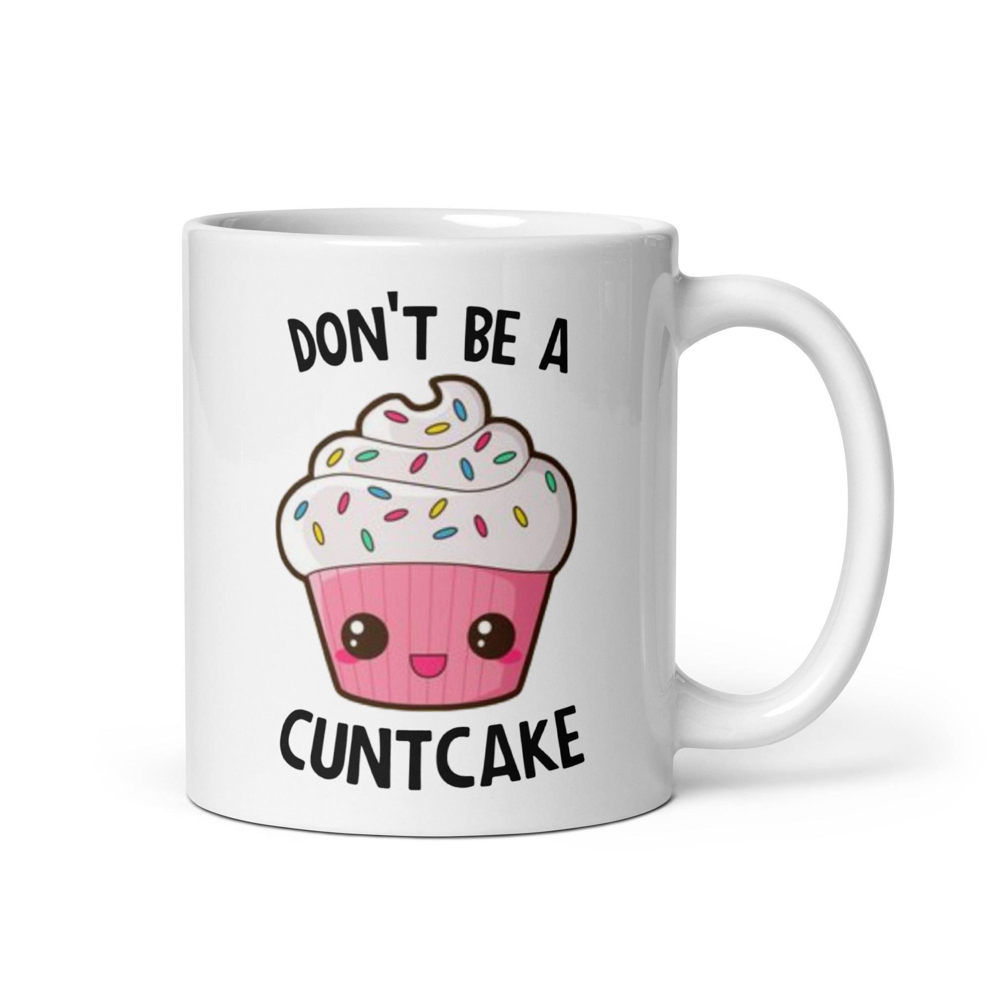 A glossy ceramic mug with the phrase 'Don't Be A Cuntcake' printed on both sides, available in two sizes.