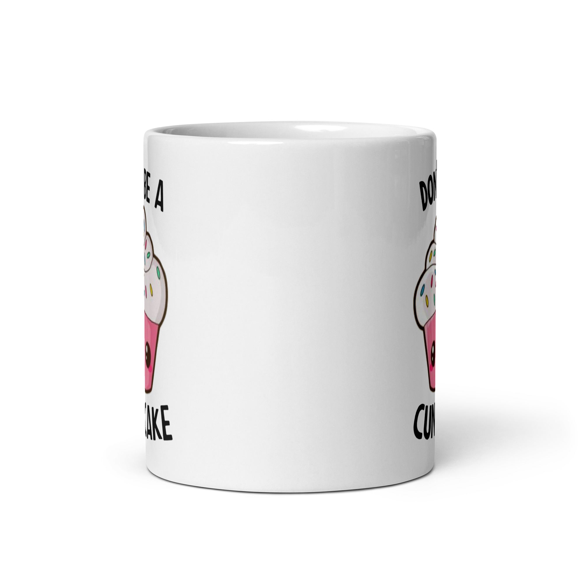 A glossy ceramic mug with the phrase 'Don't Be A Cuntcake' printed on both sides, available in two sizes.