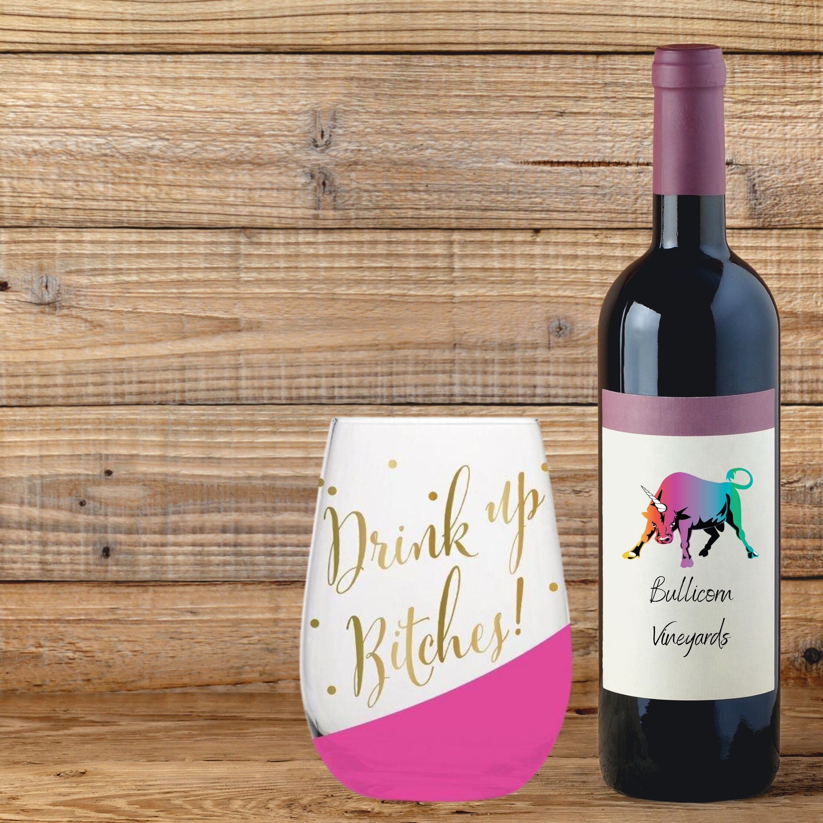 Stylish stemless wine glass with gold lettering saying 'Drink Up Bitches!' and pink slant detail, perfect for parties.