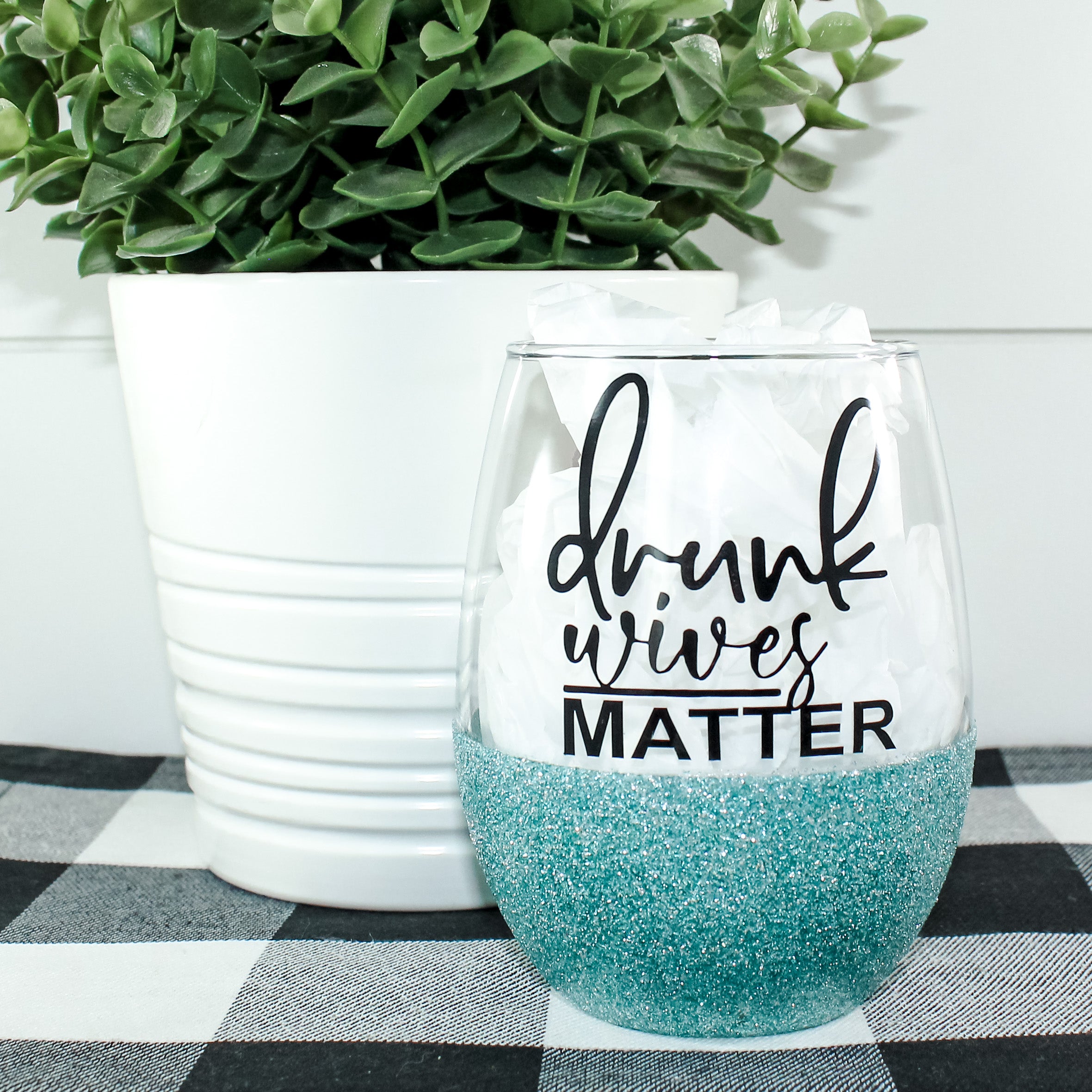 Drunk Wives Matter Glitter Wine Glass with colorful glitter design, stemless style, and printed text.