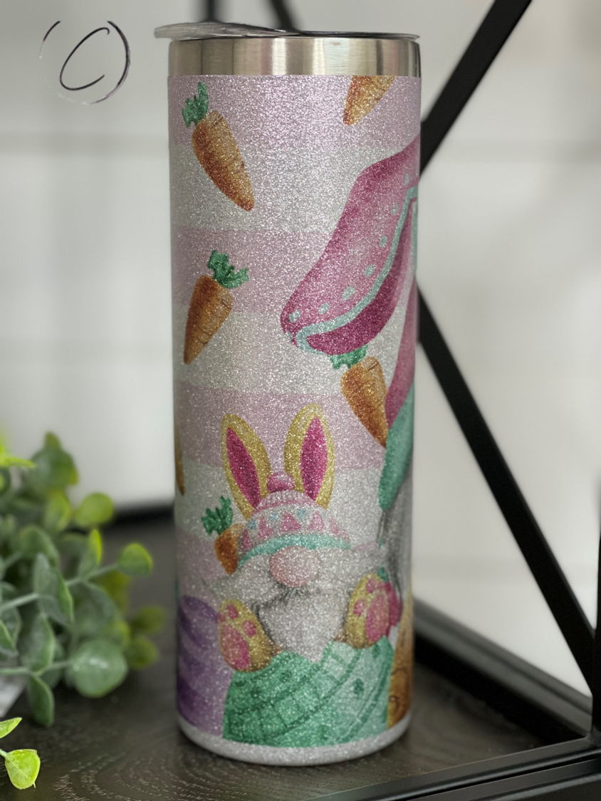 Easter Bunny Gnomes 20oz Glitter Skinny Tumbler with a vibrant glitter finish and a reusable straw.