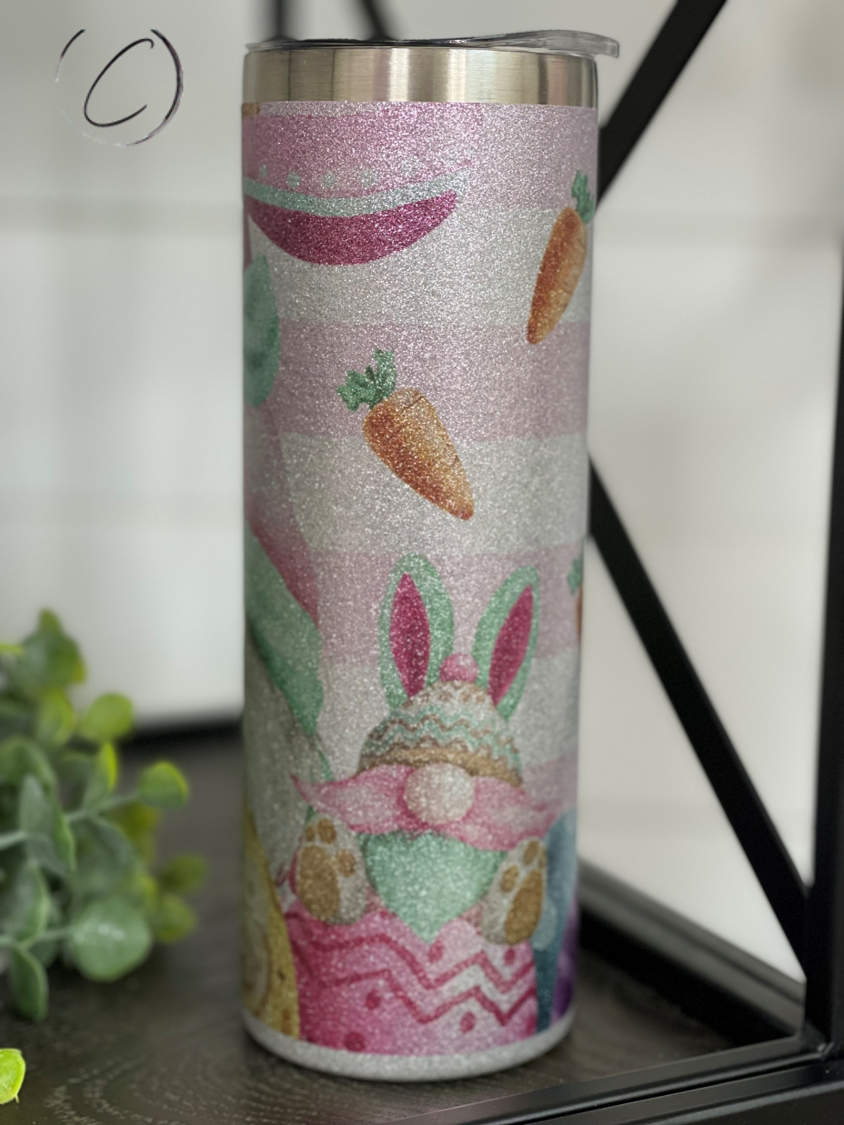 Easter Bunny Gnomes 20oz Glitter Skinny Tumbler with a vibrant glitter finish and a reusable straw.