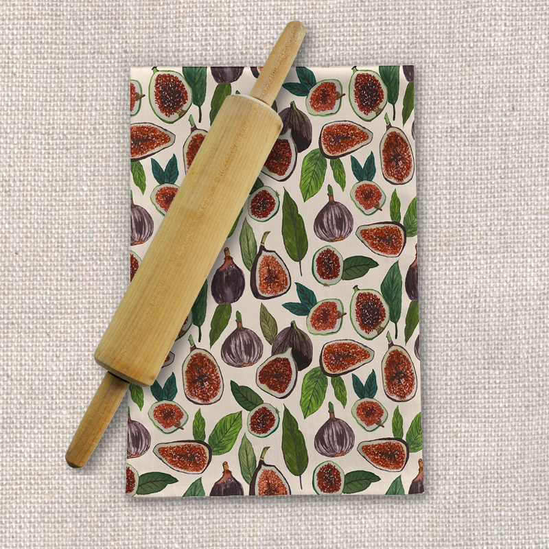 A cozy fig-themed tea towel made of cotton twill, featuring a beautiful fig design, perfect for kitchen decor and practical use.