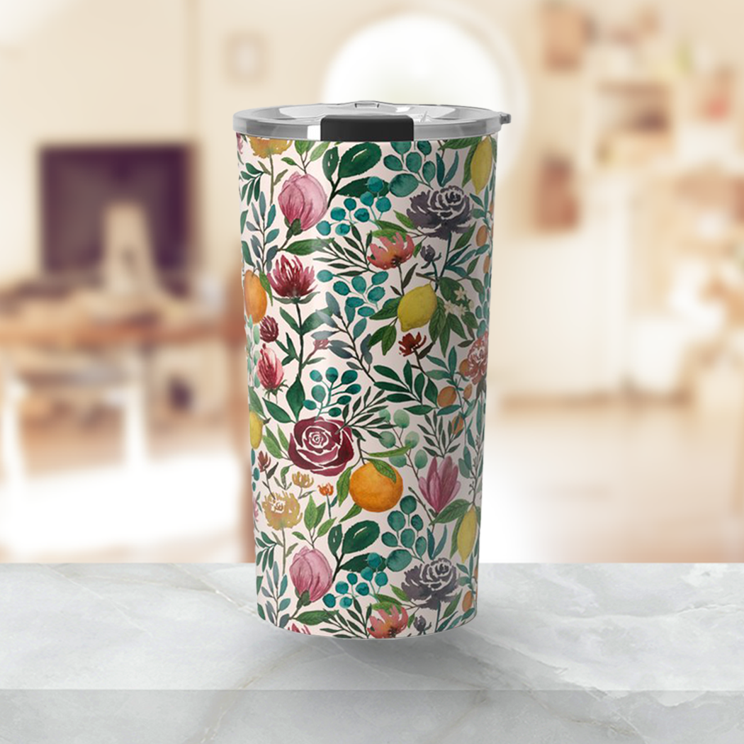 A vibrant 20oz stainless steel travel mug featuring a colorful fruit and flower design, perfect for hot or cold beverages.