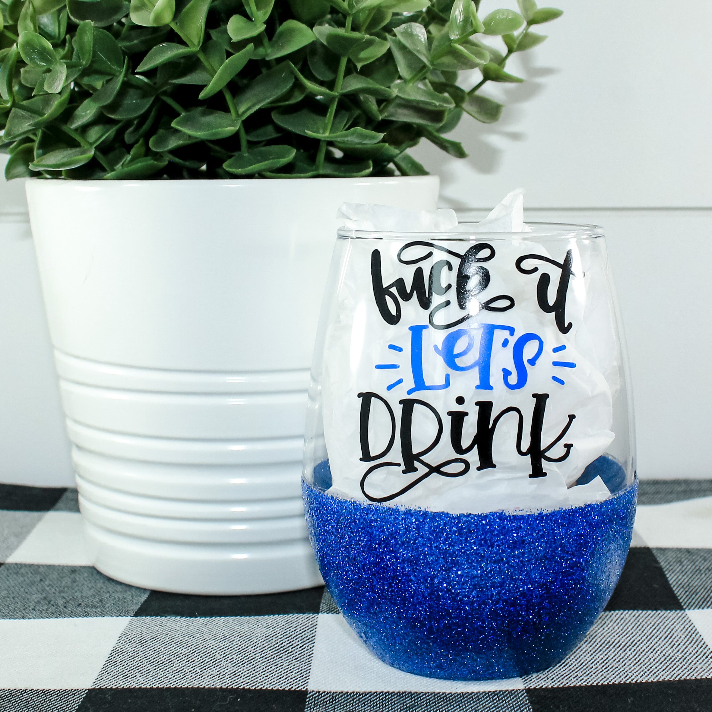 A beautiful stemless wine glass adorned with sparkling glitter, showcasing a fun design perfect for celebrations.