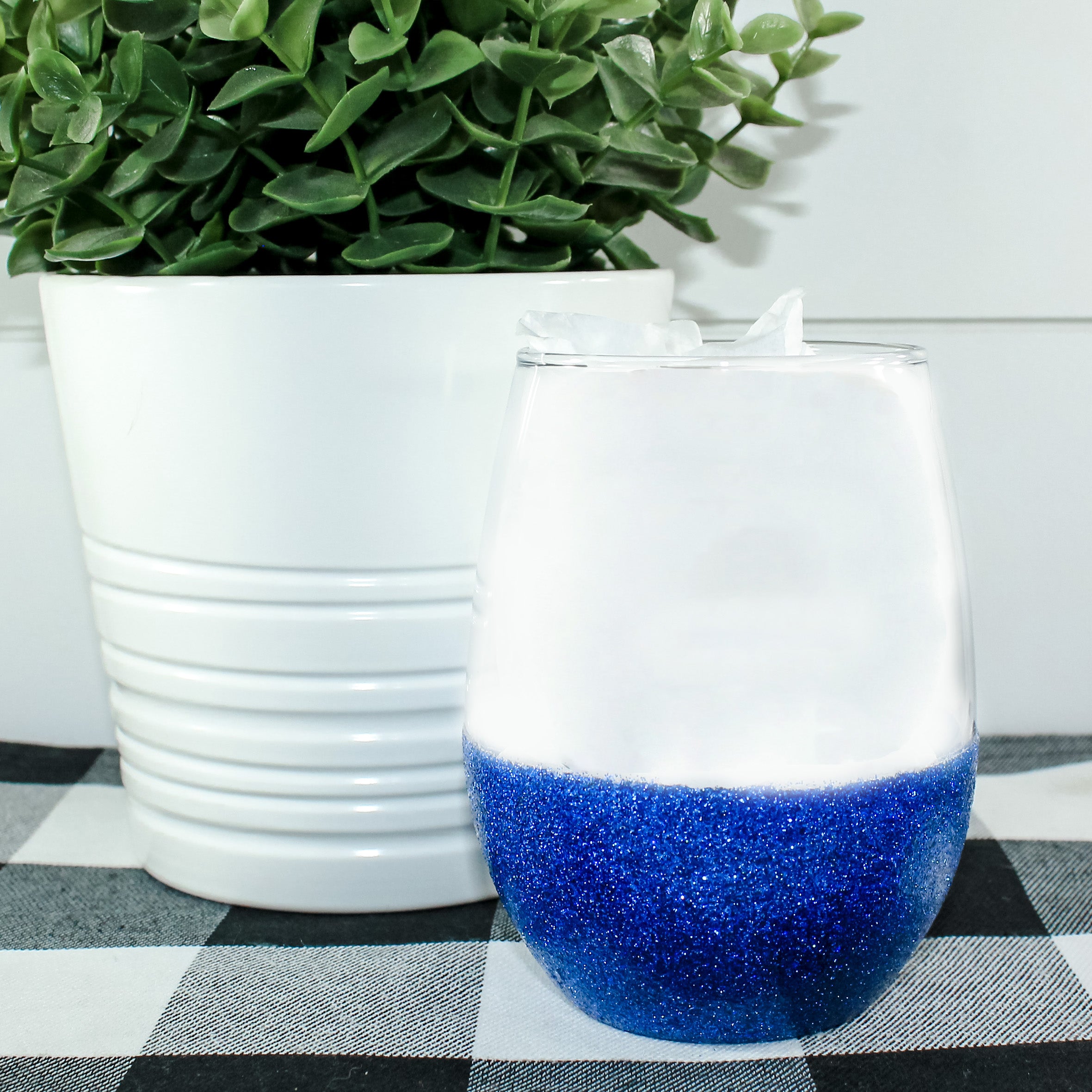 A beautiful stemless wine glass adorned with sparkling glitter, showcasing a fun design perfect for celebrations.