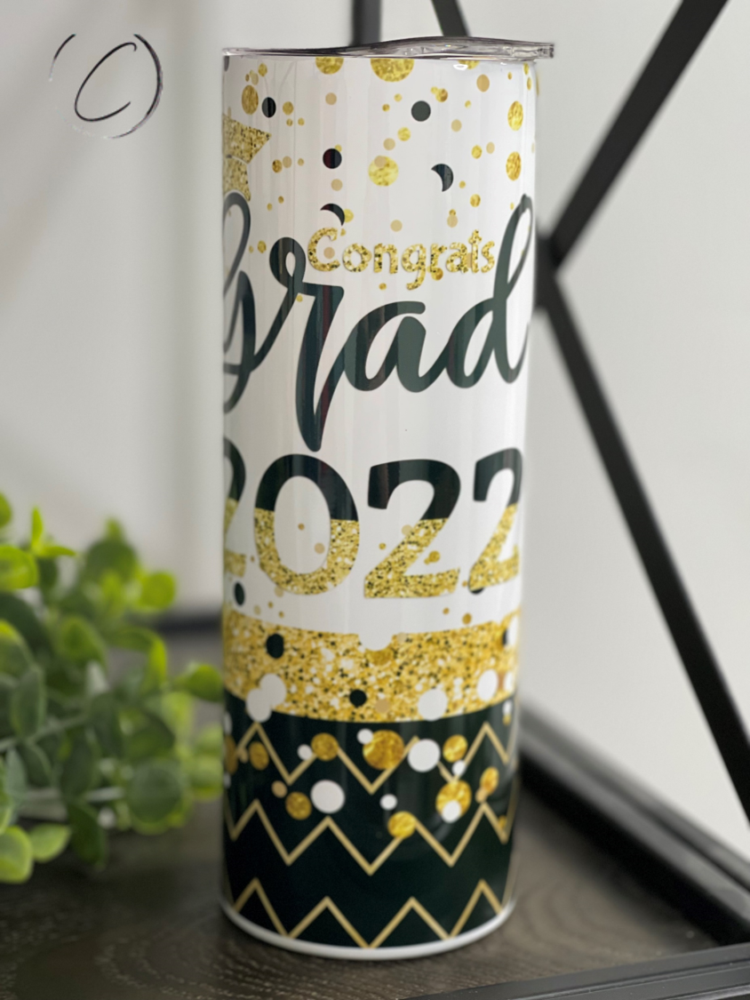 A stylish 20oz Skinny Tumbler celebrating graduation 2022 with a full wrap design and reusable straw.