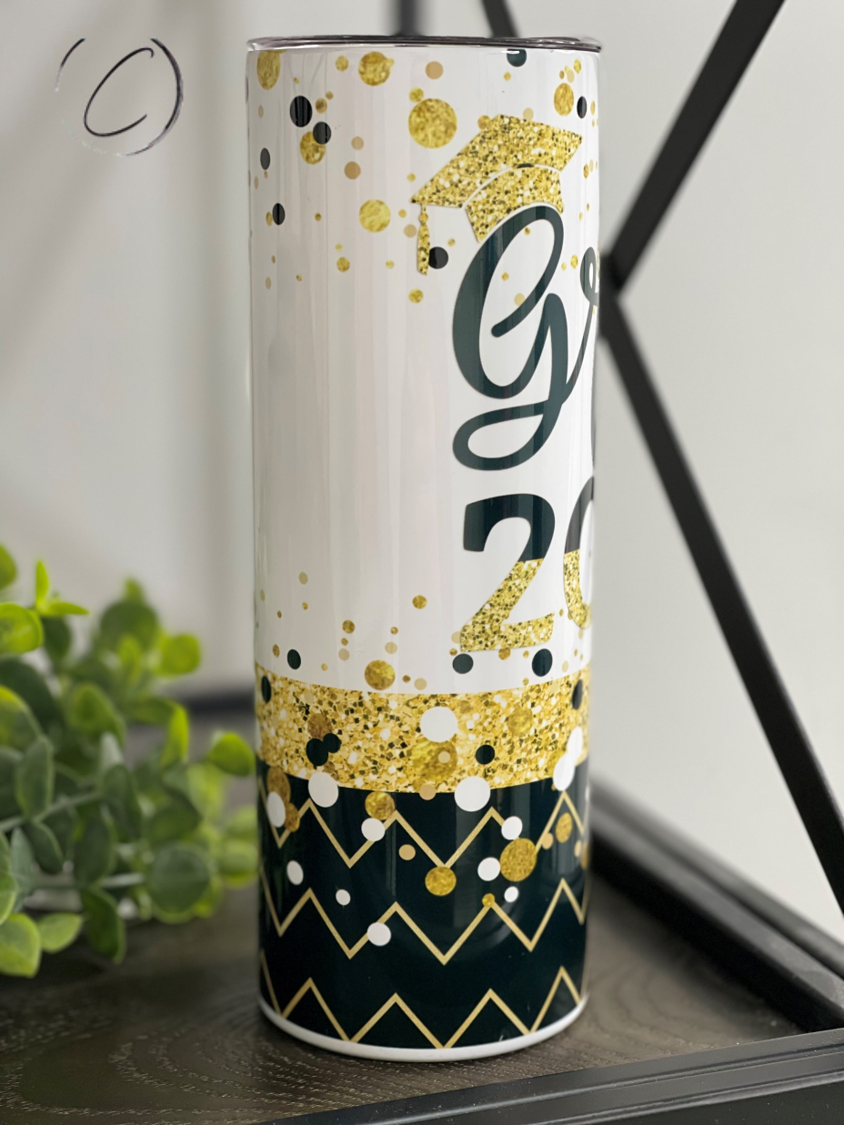 A stylish 20oz Skinny Tumbler celebrating graduation 2022 with a full wrap design and reusable straw.